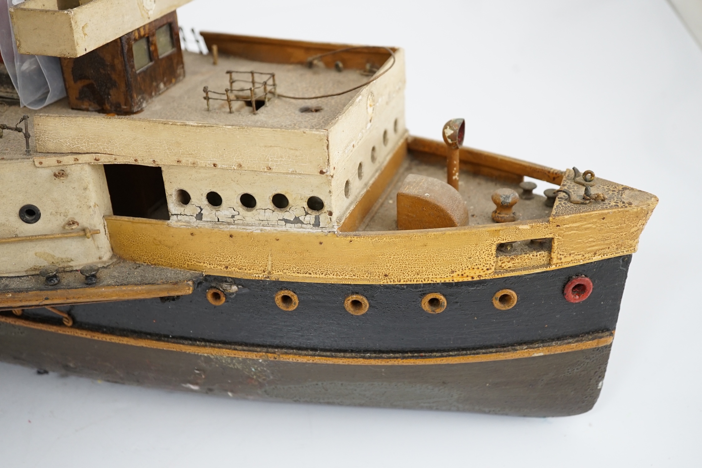 A wooden model of a paddle steamer, with a well detailed deck and with some age to the model, however now requiring some restoration, 80cm long